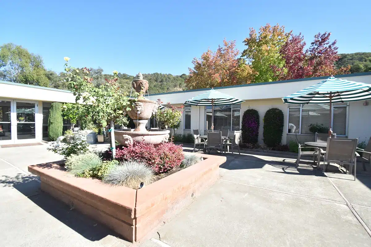 The courtyard with a fountain and flowers at Marin Post Acute
