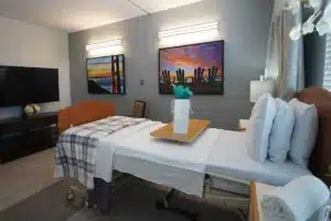 A resident's bedroom with paintings on the walls at Marin Post Acute