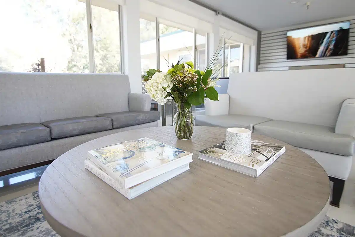 A table with books and flowers at Marin Post Acute